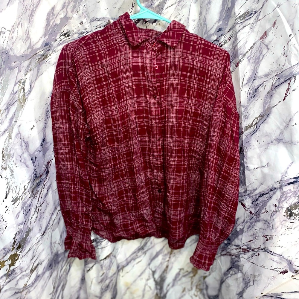 Burgundy EM button up blouse with flared sleeves.